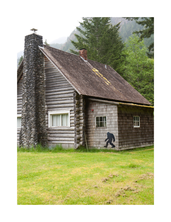 Bigfoot against a wall of a cabin